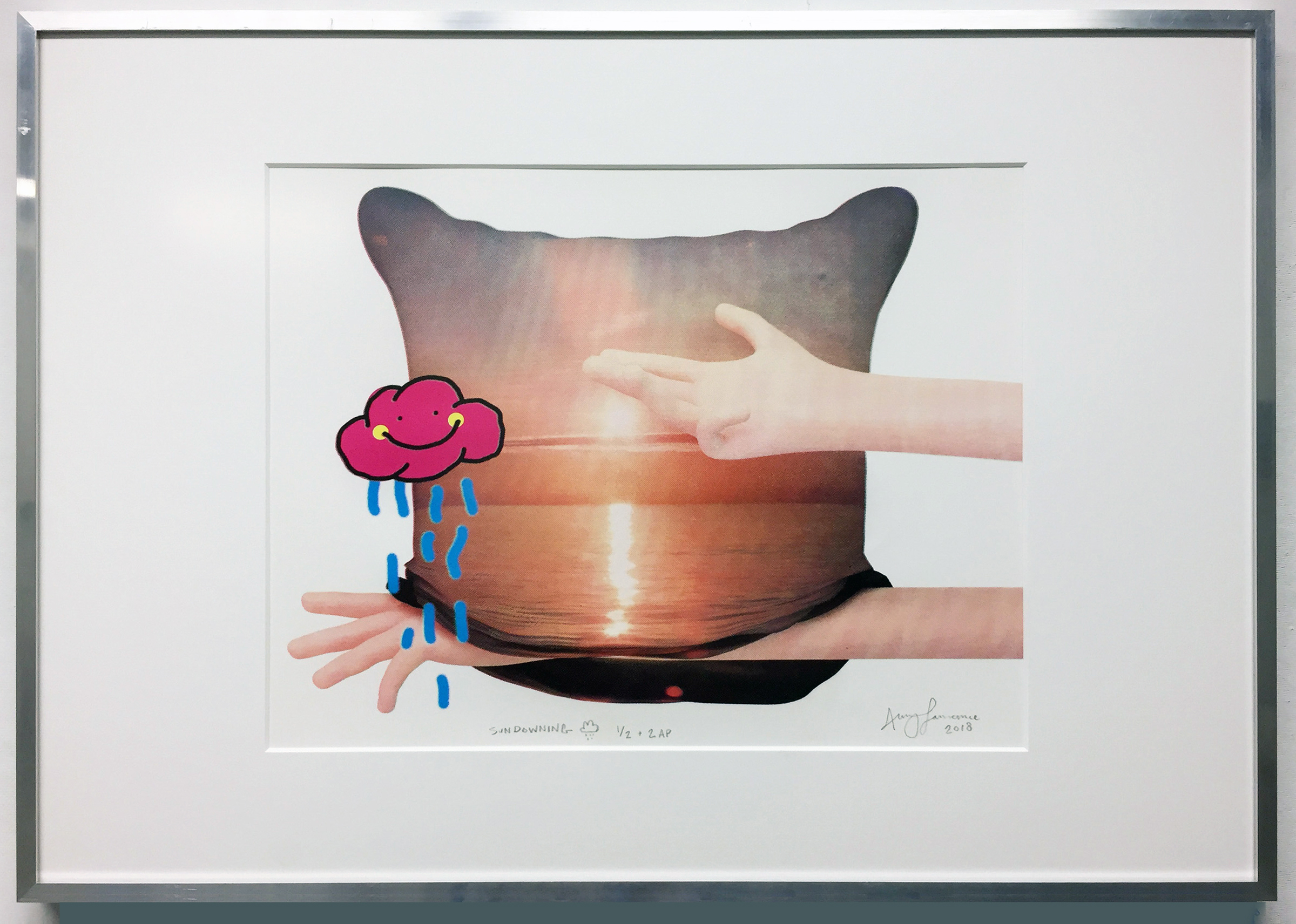 A photograph of a screen-printed image of two pink arms interacting with a pillow and a cartoon, pink rain cloud.